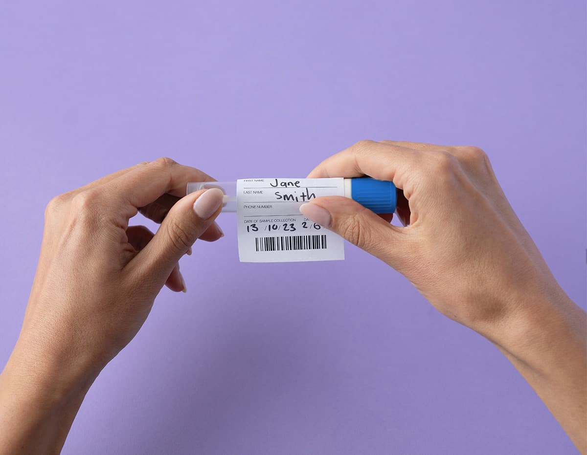 putting a Lumi Sample ID barcode on a swab