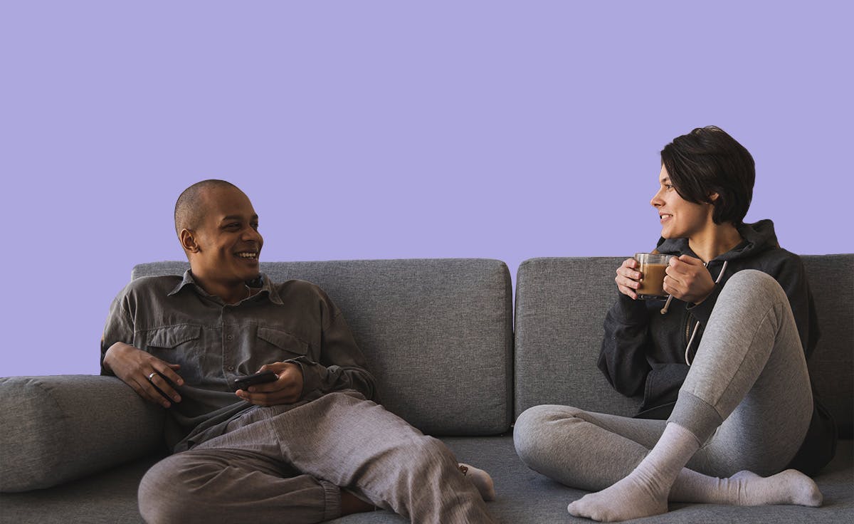 a couple discussing carrier screening on a couch