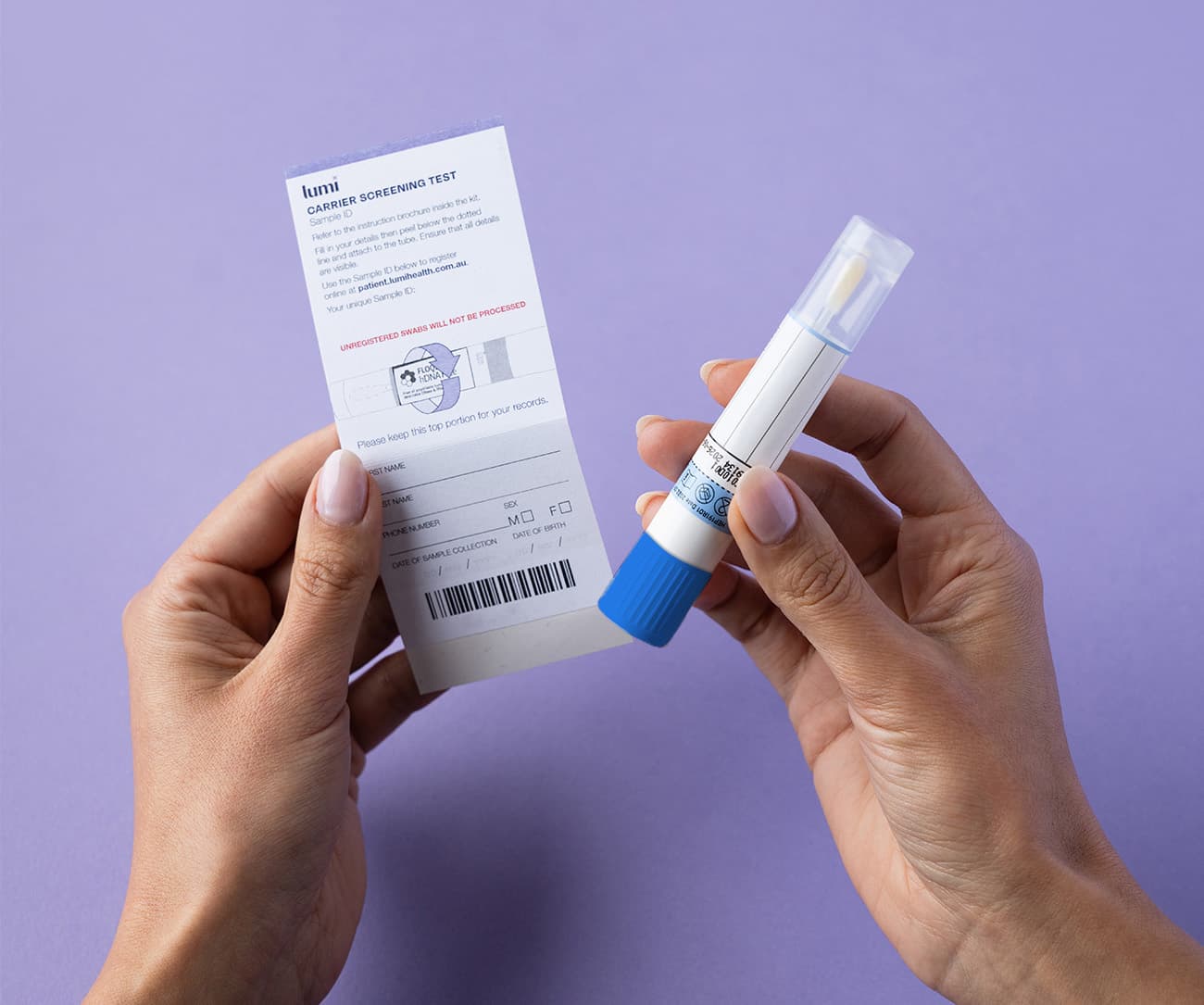 a close up of hands holding a Lumi Sample ID and swab